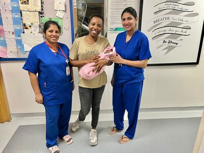 Winnie Atieno Muga, holding her baby Shaniqua, with nurses at Aster Hospital – Mankhool in Dubai