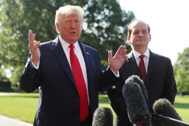 President Donald Trump speaks to members of the media with Secretary of Labor Alex Acosta. AP 