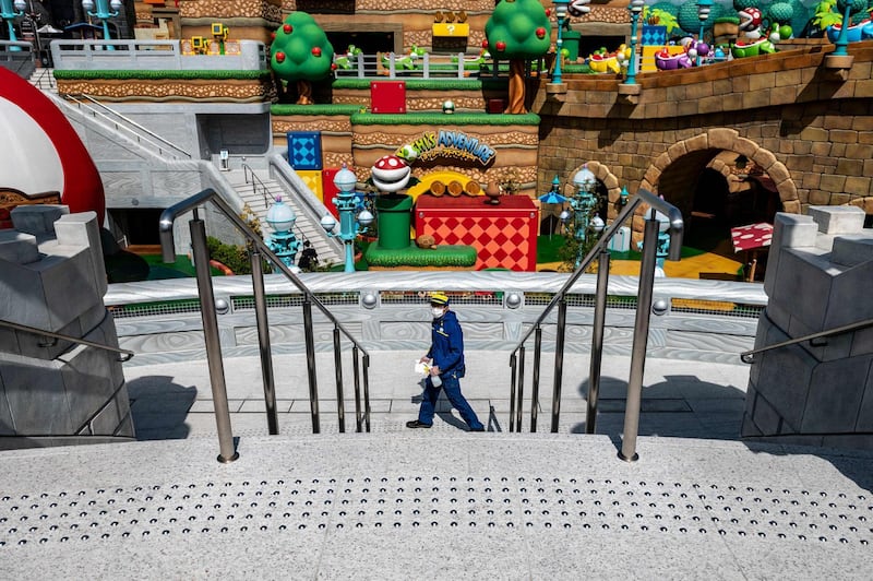 A staff member cleans the facilities as a preventative measure against the Covid-19 coronavirus during a media preview of the Super Nintendo World at Universal Studios Japan in Osaka. AFP