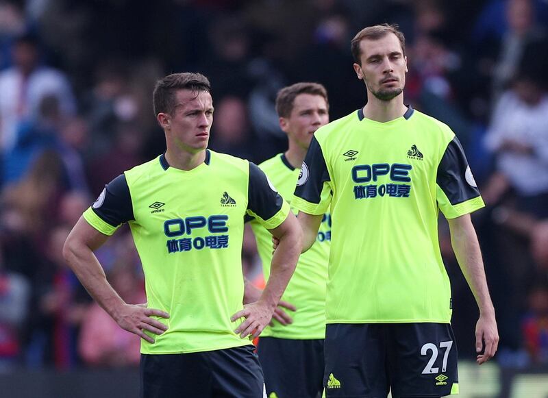 Huddersfield Town's Jon Gorenc Stankovic and team mates look dejected after the match. Reuters