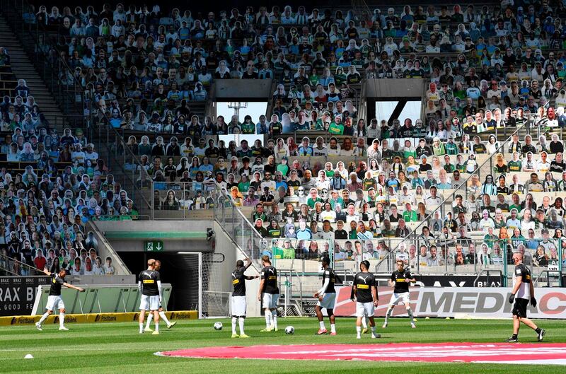 Cardboards with photos of Moenchengladbach fans are seen on the stands during warm up. AFP
