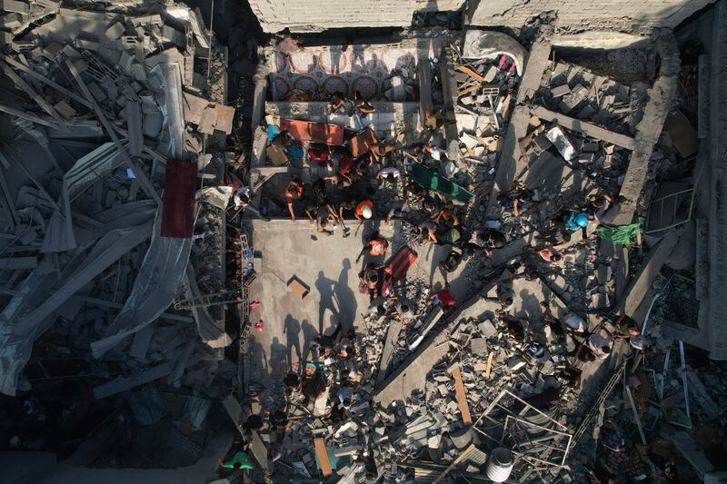 Palestinians inspect the rubble of buildings hit by an Israeli air strike at Al Shati refugee camp. AP