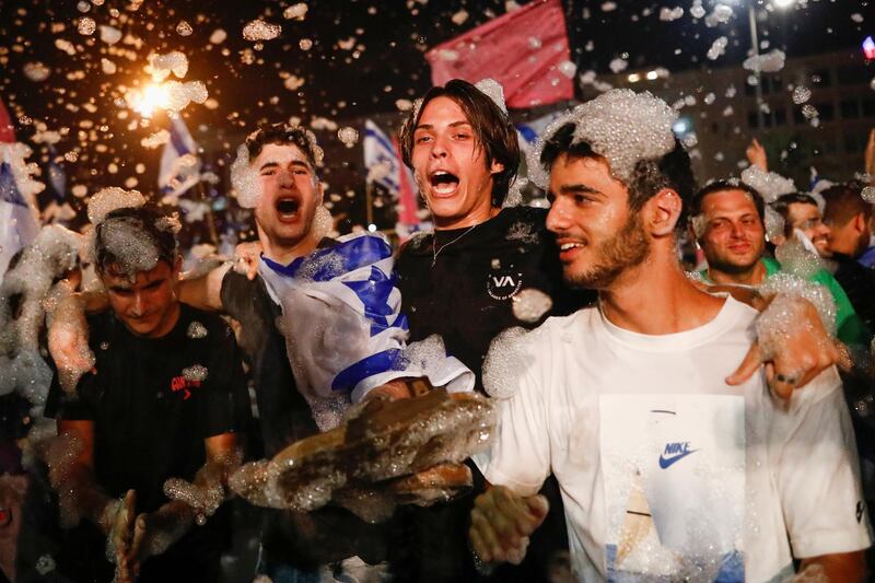 People celebrate after Israel's parliament voted in a new coalition government, ending Benjamin Netanyahu's 12-year hold on power, at Rabin Square in Tel Aviv, Israel. Reuters