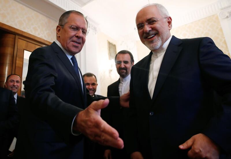 Russian Foreign Minister Sergei Lavrov (L) and his Iranian counterpart Mohammad Javad Zarif smile during their meeting in Moscow on May 14, 2018. / AFP / POOL / MAXIM SHEMETOV

