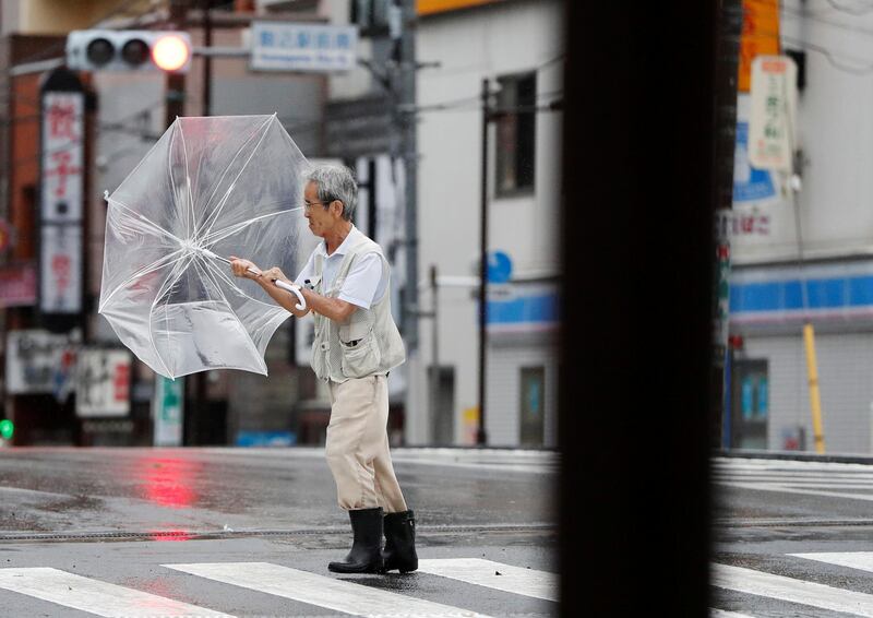 A man using an umbrella struggles against heavy rain and wind wind caused by Typhoon Faxai in Tokyo, Japan September 9, 2019. REUTERS/Issei Kato