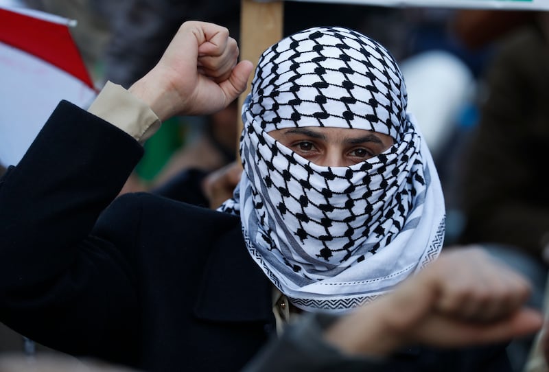 A protester in Sana'a, Yemen, covering his face with a keffiyeh. EPA