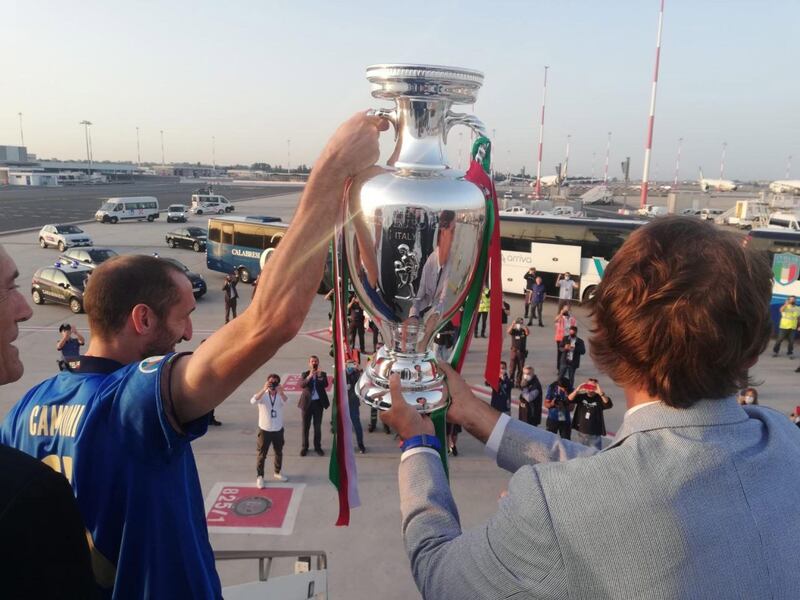 Italy captain Giorgio Chielliniand manager Roberto Mancini with the European Championship trophy after arriving at Rome's Leonardo Da Vinci airport.