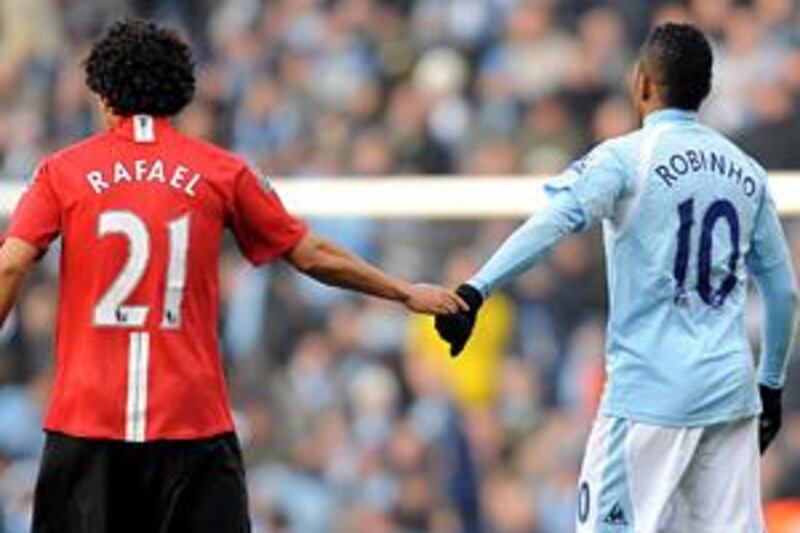 Manchester United's Rafael, left, keeps City's Robinho at arms length in this season's first Manchester derby, which United won 1-0.