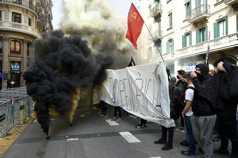 TOPSHOT - Protesters ignite smoke grenades during a student demonstration. AFP