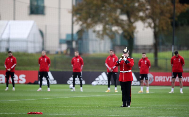 The Last Post is played as Wales football team players observe a silence in Pontyclun. PA