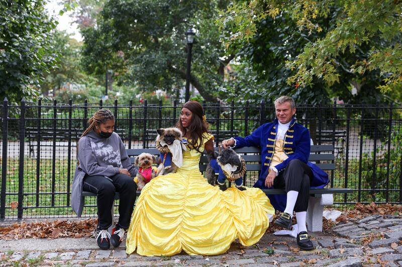 Tiffany Frasier as Belle from 'Beauty and the Beast', waits for a cab with friends after participating in the parade. Reuters