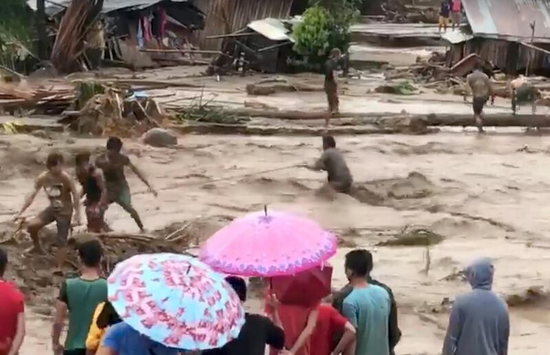 People help rescue flood victims in Lanao Del Norte, Philippines, December 22, 2017 in this image taken from video footage obtained from social media. Climah Cabugatan Disumala / Reuters