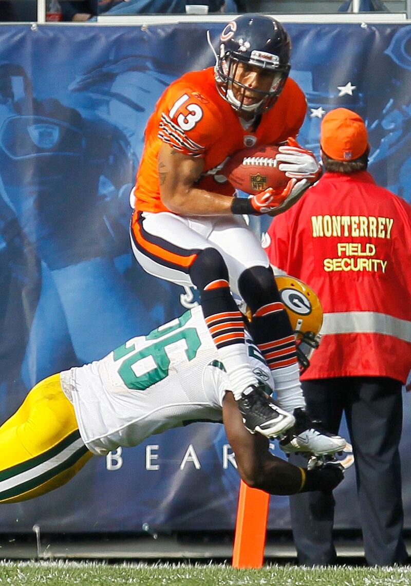 Chicago Bears wide receiver Johnny Knox (13) catches a pass and is tackled by Green Bay Packers defensive back Charlie Peprah (26) in the first half of an NFL football game in Chicago, Sunday, Sept. 25, 2011. (AP Photo/Charles Rex Arbogast) *** Local Caption ***  Packers Bears Football.JPEG-02df9.jpg