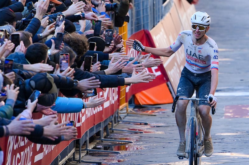 UAE Team Emirates rider Tadej Pogacar celebrates while crossing the finish line to win the Strade Bianche in Siena, Italy, on Saturday, March 2, 2024. AP