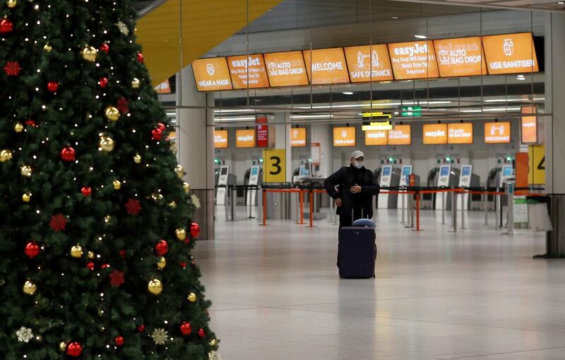 FILE PHOTO: A passenger stands in an almost empty check-in area at Gatwick Airport, amid the coronavirus disease (COVID-19) outbreak, in Crawley, Britain, November 27, 2020.  REUTERS/Peter Nicholls/File Photo