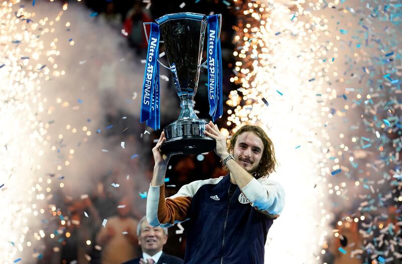 Stefanos Tsitsipas of Greece lifts his trophy after winning the final match against Dominic Thiem of Austria at the ATP World Tour Finals tennis tournament in London. EPA