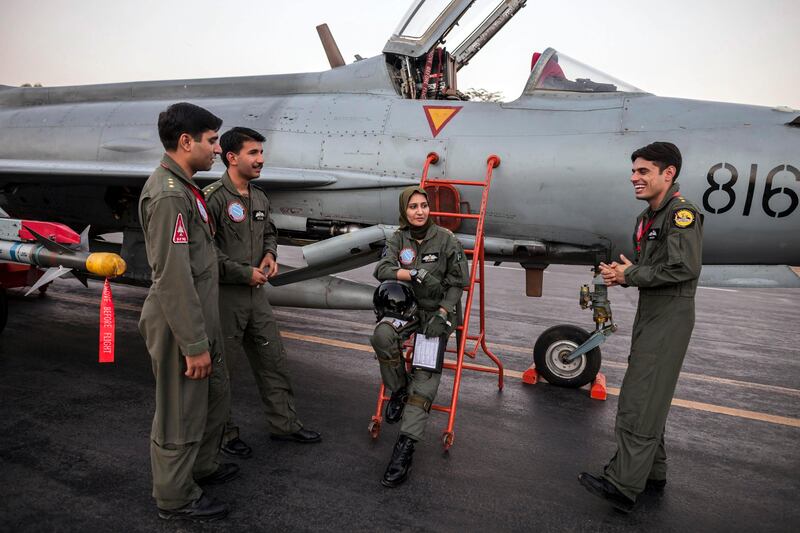 Ayesha Farooq, 26, (C) Pakistan's only female war-ready fighter pilot, chats with her colleagues beside a Chinese-made F-7PG fighter jet at Mushaf base in Sargodha, north Pakistan June 6, 2013. Farooq, from Punjab province's historic city of Bahawalpur, is one of 19 women who have become pilots in the Pakistan Air Force over the last decade - there are five other female fighter pilots, but they have yet to take the final tests to qualify for combat. A growing number of women have joined Pakistan's defence forces in recent years as attitudes towards women change. Picture taken June 6, 2013. REUTERS/Zohra Bensemra (PAKISTAN - Tags: MILITARY SOCIETY TPX IMAGES OF THE DAY) *** Local Caption ***  ZOH01_PAKISTAN-AIRF_0612_11.JPG