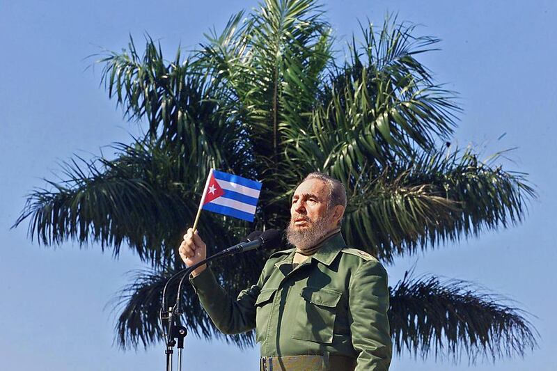 Cuban President Fidel Castro waves a flag during during a visit  on January 27, 2001, to the Havana neighborhood of San Jose de las Lajas.  Adalberto Roque / AFP 

