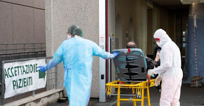 epa08327511 A patient is brought into the pre-triage zone, for all patients, seen during a guided visit to the new Covid-19 ward of the Tor Vergata Hospital in Rome, Italy, 27 March 2020.  EPA/MAURIZIO BRAMBATTI