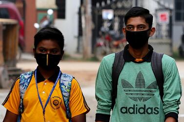 epa08276067 Indian students walk wearing protective masks as a precaution against the coronavirus outbreak, in Bangalore, India, 07 March 2020. According to media reports, 32 persons in India have been tested positive for coronavirus, which causes the COVID-19 disease. EPA/JAGADEESH NV