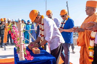Kumar places a brick that will later be used in the Hindu temple construction in Abu Dhabi