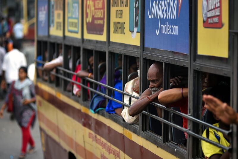 A passenger at the Broadway bus terminus in Chennai, the capital of Tamil Nadu, defies a state anti-coronavirus mandate to wear a mask as case numbers rise.   EPA