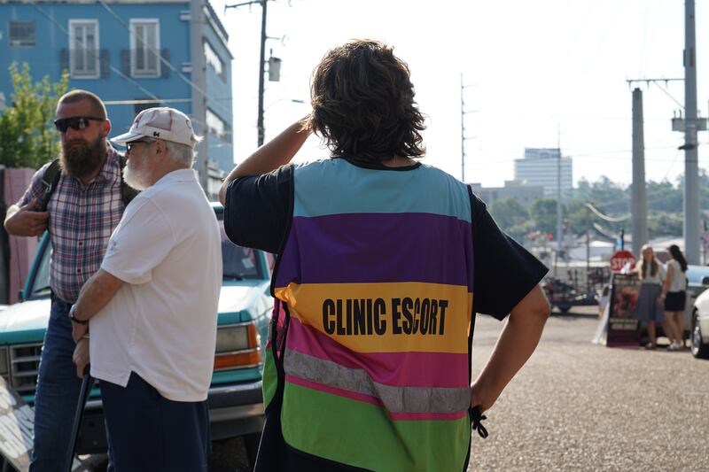 A clinic escort looks down the street at anti-abortion protesters outside of the Jackson Women's Health Organisation. Willy Lowry / The National 