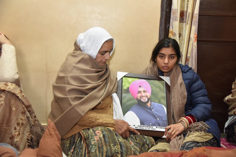 The mother of Abu Dhabi blast victim Hardeep Singh, Charanjit Kaur, and his widow Kanupriya Kaur, at their home in Mehsampur village, in India’s Punjab state during a prayer ceremony. Prabhjot Gill/ The National