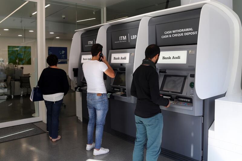 Customers use automated teller machines (ATM) at a Bank Audi SAL bank branch in Beirut, Lebanon, on Tuesday, Oct. 29, 2019. "I tried throughout this period to find a way out so we could listen to the people’s voices and protect the country," Lebanese Prime Minister Hariri said hours after supporters of Iranian-backed Hezbollah attacked anti-government protesters in Beirut and destroyed their tents. Photographer: Hasan Shaaban/Bloomberg