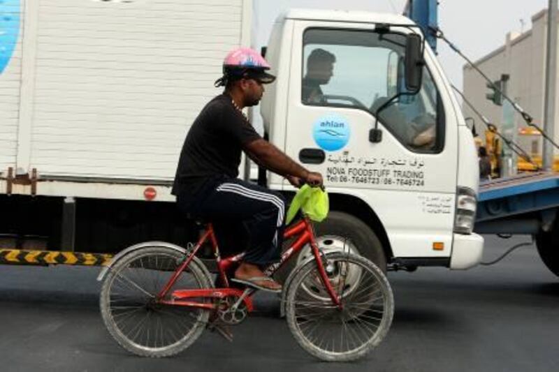 DUBAI, UNITED ARAB EMIRATES Ð Nov 23: One of the cyclist wearing helmet on his bicycle at Al Quoz industrial area in Dubai. (Pawan Singh / The National) For Weekender.