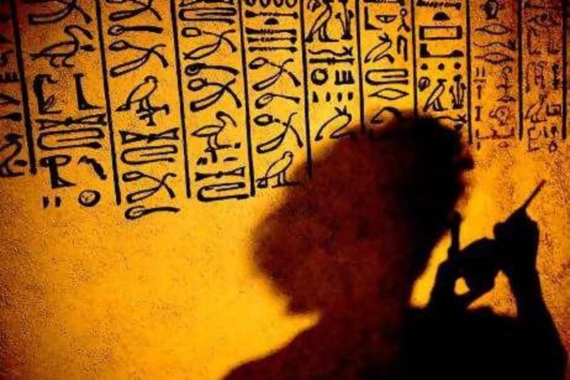 An employee of the Westlausitz museum paints hieroglyphics on the wall of a reproduced Egyptian grave-chamber in preparation of the exhibition "Ex Oriente Lux - Treasures from Private Collections from the Oberlausitz" on June 23, 2010 in Kamenz, eastern Germany. From June 26, 2010 to April 10, 2011, the museum presents art objects and treasures from Asia and the Mediterranean.      AFP PHOTO    ARNO BURGI    GERMANY OUT