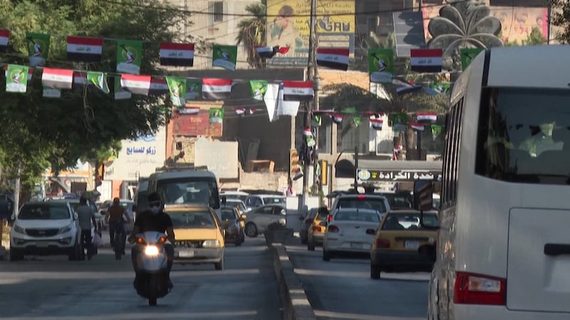 Iraqi flags are strung across a street.