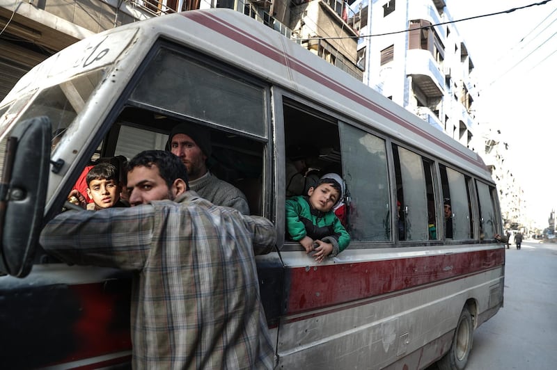 A boy looks out from a bus during the evacuation in rebels-held Douma, Syria, on March 17, 2018. Mohammed Badra / EPA