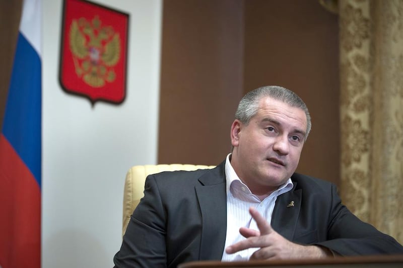 Crimean prime minister Sergei Aksyonov has defended the decision to forcibly take over dozens of businesses and properties since coming to power in March. Alexander Zemlianichenko / AP Photo