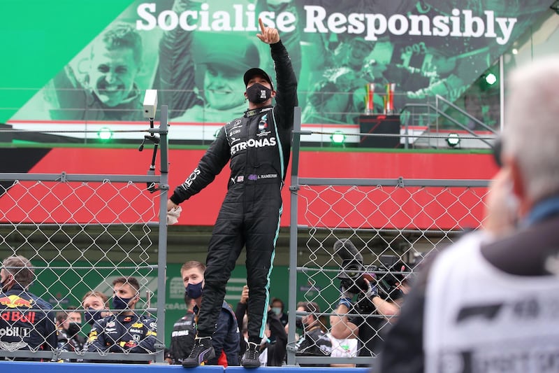 Lewis Hamilton celebrates his record-breaking victory. AFP