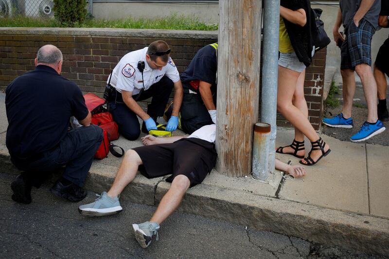 Cataldo Ambulance medics and other first responders revive a 32-year-old man who was found unresponsive and not breathing after an opioid overdose on a sidewalk in the Boston suburb of Everett, Massachusetts, on August 23, 2017. Reuters
