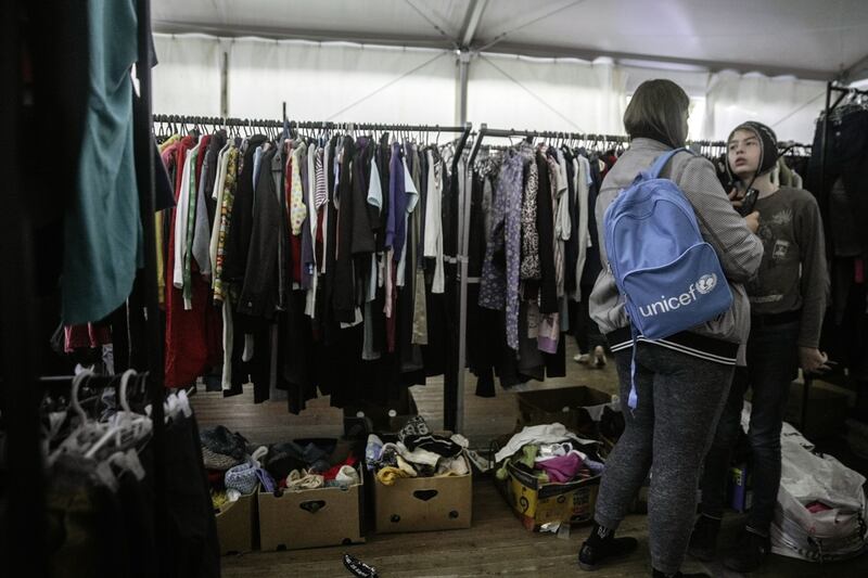 Visitors try on donated used clothes at a humanitarian aid hub for internally displaced people in Odesa, southern Ukraine. Bloomberg