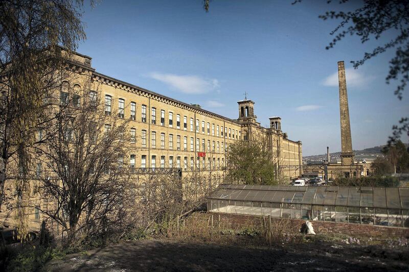 BRADFORD, UNITED KINGDOM - MARCH 30:  A mill built by Sir Titus Salt stands at Saltaire Village World Heritage Site on March 30, 2012 in Bradford, United Kingdom. Saltaire is named after Sir Titus Salt who built a textile mill and housing for his workers on the banks of the River Aire. In 2001 the historic industrial village was granted a World Heritage Site by UNESCO.  (Photo by Bethany Clarke/Getty Images)