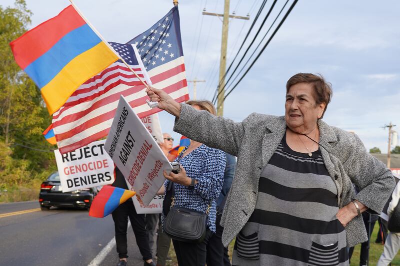 A woman holds up an Armenian flag at a protest in Pennsylvania against Dr Oz.