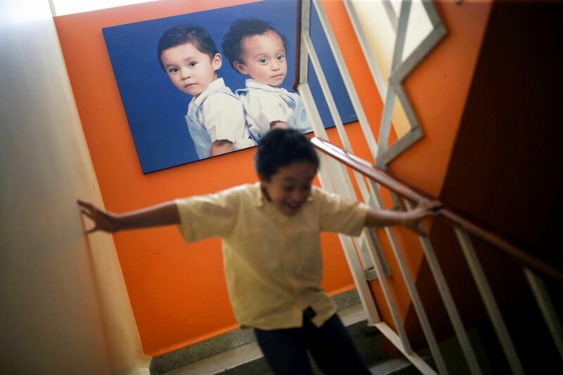 Fernando, 8, runs during a day of online classes inside his house, as Mexico marks one year anniversary of homeschooling after the schools closed due to the coronavirus disease pandemic in Mexico City, Mexico. Reuters