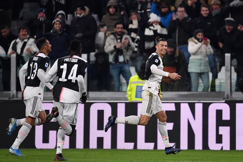Juventus' Portuguese forward Cristiano Ronaldo (R) celebrates after opening the scoring during the Italian Serie A football match Juventus vs Parma on January 19, 2020 at the Juventus stadium in Turin. (Photo by Marco Bertorello / AFP)