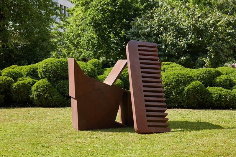 A Corten steel comb sculpture by New York-based artist Wyatt Kahn sits on the lush grass at Haus zum Raben. Photo: Art Basel