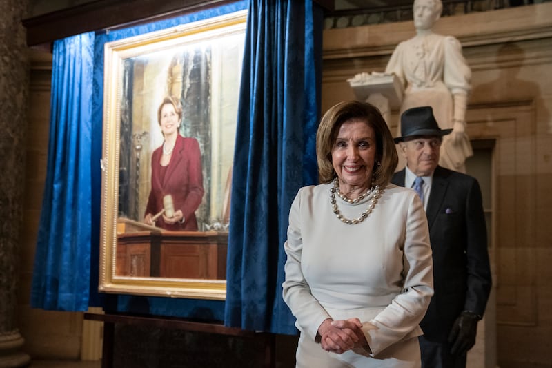 US House Speaker Nancy Pelosi, left, and husband Paul Pelosi, right, during the unveiling of a portrait of Ms Pelosi at the US Capitol, in Washington.   EPA
