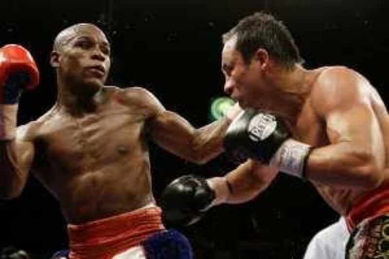 Floyd Mayweather Jr., left, connects with Juan Manuel Marquez, of Mexico, during their non-title welterweight boxing match in Las Vegas, Saturday, Sept. 19, 2009.  (AP Photo/Laura Rauch) *** Local Caption ***  NVDP143_APTOPIX_Mayweather_Marquez_Boxing.jpg