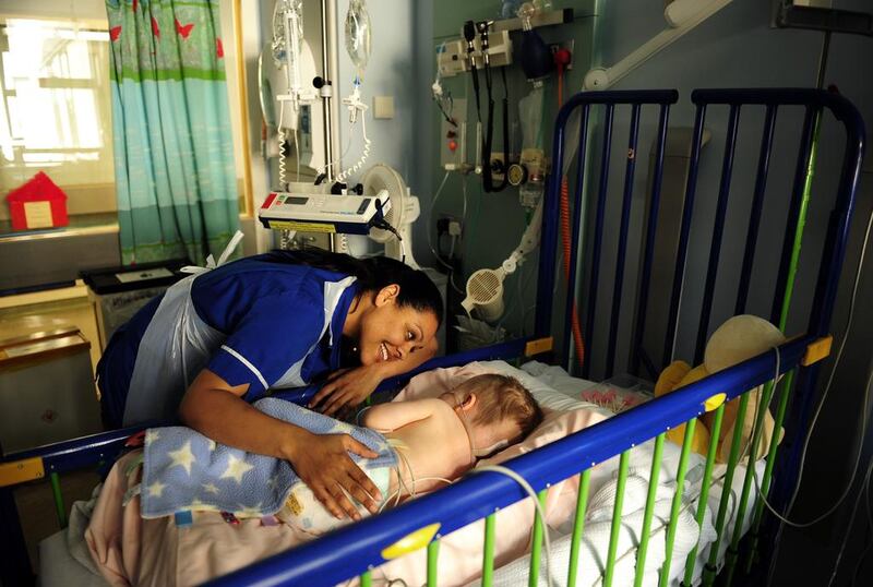 A nurse comforts a patient at the Great Ormond Street Hospital, the UK’s best-known children’s hospital. Dylan Martinez / Reuters