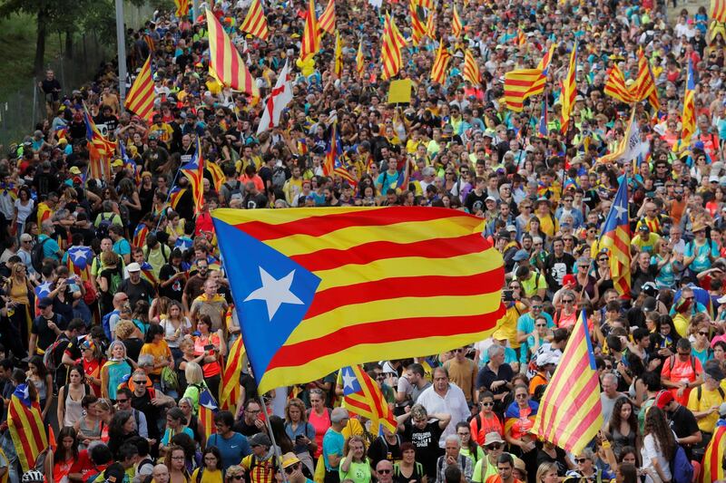 Catalan demonstrators wave Esteladas (Catalan separatist flags) as they block roads during Catalonia's general strike in Sant Just Desvern, Spain, October 18, 2019. REUTERS/Juan Medina