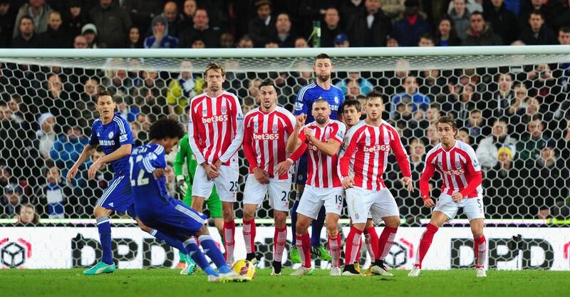 Chelsea player Gary Cahill pops up in the Stoke defensive wall as Willian prepares to take the kick during the Barclays Premier League match between Stoke City and Chelsea at Britannia Stadium on December 22, 2014 in Stoke on Trent, England.  (Photo by Stu Forster/Getty Images)