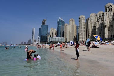 People swimming at Jumeirah Beach residence in Dubai on March 20, 2020. AFP / Giuseppe CACACE