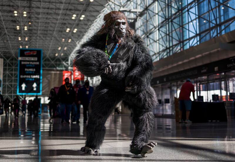 A man in a gorilla costume runs through the Jacob K Javits Convention Centre, at the first day of New York Comic Con. Many people attend dressed as their favourite fictional character. EPA