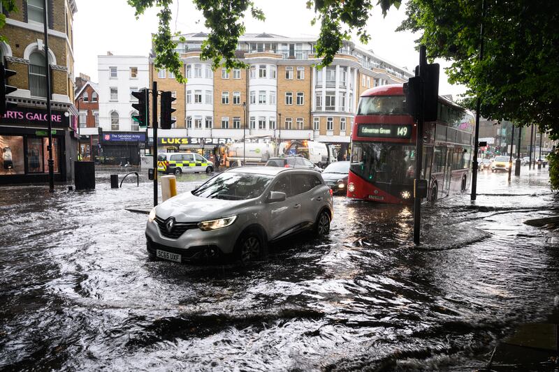 A car negotiates a flooded section of road, as torrential rain and thunderstorms hit the country on August 17, 2022 in London, England. Getty Images